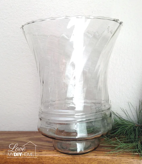 A single large votive paired with a candle stand